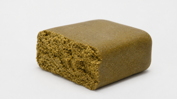 Blonde hash concentrate showing its light golden color and pressed texture.