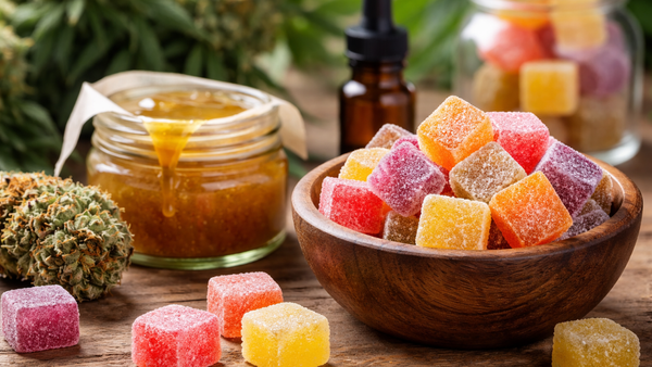 Hash rosin gummies with cannabis and extract on table