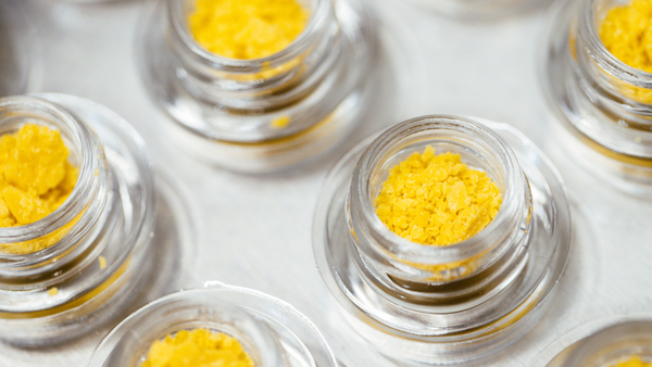 Close-up of premium cannabis concentrate jars showcasing Gold Canna's quality craftsmanship.