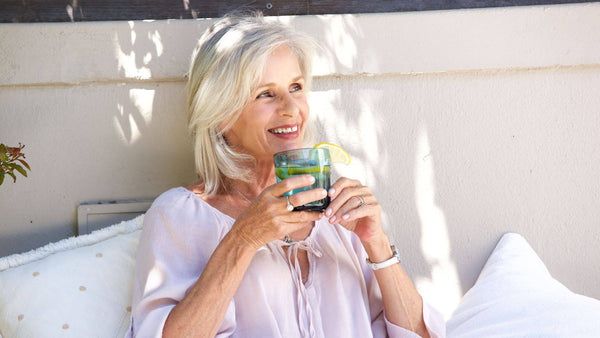Senior woman enjoying a relaxed moment outdoors, reflecting the balance and comfort many older adults look for in their daily wellness routine.